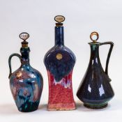 Three Fournier Demars St-Amand flamed glazed stone ware liquor bottles, Gin, Sherry and Brandy,