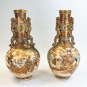 A pair of Japanese Satsuma two handled large vases, with dragon handles, decorated all around, h.