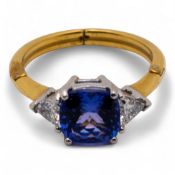 18ct yellow Gold ring set tanzanite with trillion cut diamond set shoulders. Ring size O, but adjust