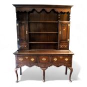Quality reproduction Oak Welsh dresser. Three drawer, Queen Anne supports. Plate rack with two