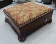 Edwardian mahogany low upholstered footstool raised on bun feet, 37cm x 37cm x 15cm.