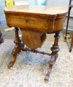 Victorian burr-walnut inlaid games table. Fold out lid and two lower storage draws. Stands on carved