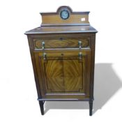 Mahogany music cabinet raised on stretchered square supports, single drawer above a fall-front