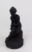 A Wedgwood black basalt figurine of a seated Psyche, on a circular base, with impressed marks,