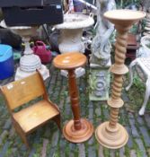 Two turned wooden torcheres, together with a child's small chapel-type chair, height of tallest