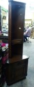 Dark Oak carved corner cupboard. Lower cupboard storage with removable top shelving section. H