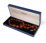 A string of Baltic Amber beads with silver clasp, 22g,with matching earrings. (3)