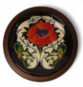 Moorcroft Plate 783/10, Poppy designer Rachel Bishop on dark blue ground measures 30cm including
