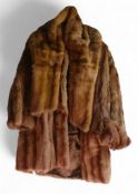 A vintage fur coat by James Smith, patterned chocolate brown lining with no rips or tears, with