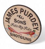 James Purdey & Sons cast iron advertising sign. (D: 24cm)