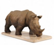 A large Resign style sculpture of a Rhinoceros presented on a marble plinth 45cm long