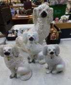Group of four Staffordshire-type dogs, height of tallest 38cm, damages noted (4).