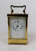 A David Peterson brass carriage clock, circa 1990, retailed by JJ Rudell & Co Ltd, with an enamelled