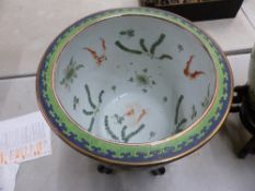 A 20th Century Chinese polychrome ceramic fishbowl of large proportions, raised on a hardwood stand,