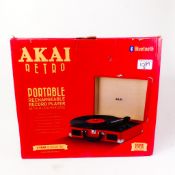 A brand-new-in-box Akai A60011NR Retro Bluetooth portable rechargeable record player with charger,
