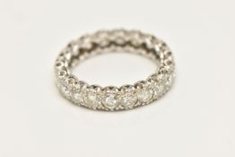 A DIAMOND FULL ETERNITY BAND RING, twenty round brilliant cut diamonds prong set in white metal,