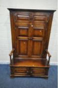 IN THE MANNER OF TITCHMARSH AND GOODWIN, A 20TH CENTURY OAK BACON SETTLE, with three pairs of