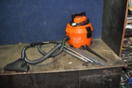 A VAX V-100 VACUUM CLEANER with floor head, two extending metal pipes, a plastic pipe and two