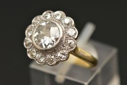 AN 18CT GOLD DIAMOND CLUSTER RING, collet set with a central old cut diamond, spreads