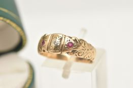 A 9CT GOLD GEM SET RING, set to the centre with a small single cut diamond, flanked with two small