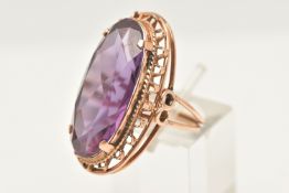 A ROSE METAL SYNTHETIC COLOUR CHANGE SAPPHIRE RING, of an oval form, set with a large oval cut