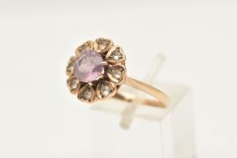 A 9CT GOLD AMETHYST AND SPINEL FLORAL CLUSTER RING, set with a central circular cut amethyst, within