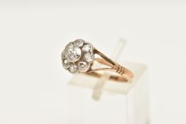 AN EARLY 20TH CENTURY DIAMOND FLORAL CLUSTER RING, nine old cut diamonds, bezel set in a white metal