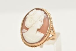 A 9CT GOLD CAMEO RING, of an oval form, set with an oval carved shell cameo depicting a lady in