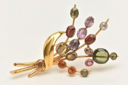 A MULTI GEM SET FLORAL SPRAY BROOCH, a yellow metal brooch, prong set with assorted oval and