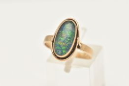 A YELLOW METAL OPAL DOUBLET RING, of an oval form, set with an opal doublet cabochon, collet set