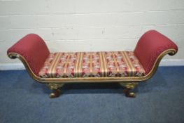 A REPRODUCTION ITALIAN STYLE WINDOW SEAT, with scrolled armrests, raised on winged padded feet,