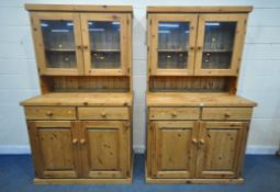 TWO MODERN PINE DRESSERS, the top section with double glass doors, atop a base with two drawers, and