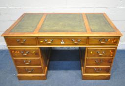 A 20TH CENTURY YEW WOOD TWIN PEDESTAL DESK, with green leather writing surface, fitted with eight