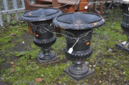 A PAIR OF EARLY 20th CENTURY CAST IRON URNS, with foliate detail and fluted bowl height 47cm (2)