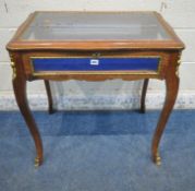 A 20TH CENTURY BIJOUTERIE TABLE, with a hinged lid, that’s enclosing a blue baize, raised on