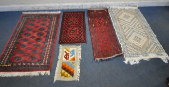 A RED GROUND RECTANGULAR RUG, with sixteen medallions, surrounded by a multi-strap border, 142cm x