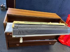 A BROTHER KH-881 KNITTING MACHINE IN A CHERRYWOOD EFFECT CABINET with rolling drawer, accessories