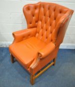 A BLOOD ORANGE LEATHER WING BACK ARMCHAIR, with button back, and swept armrests, width 80cm x