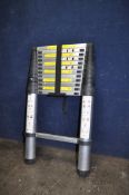 A TELESCOPIC EXTENSION LADDER with 12 rungs, max height 380cm, min height 83cm