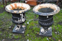 A PAIR OF EARLY 20th CENTURY CAST IRON URNS, with fluted bowls, height 50cm (2)
