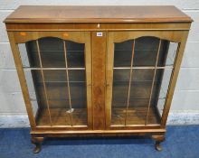 A 20TH CENTURY WALNUT DISPLAY CABINET, the double glazed doors enclosing four glass shelves,