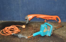 A FLYMO MINI TRIM ST STRIMMER along with a Black and Decker Hedge Trimmer (both PAT pass and
