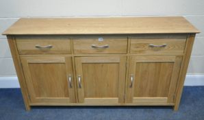 A MODERN LIGHT ASH SIDEBOARD, fitted with three drawers, over three cupboard doors, length 158cm x