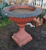 A LARGE EARLY TO MID 20th CENTURY CAST IRON GARDEN URN, with fluted bowl atop a tapered base with