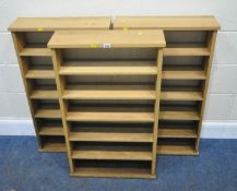 THREE MATCHING OAK SHELVING UNITS, each with five shelves, width 56cm x depth 17cm x height 96cm,