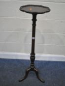 AN EARLY 20TH CENTURY MAHOGANY PLANT STAND, with a wavy edge, cylindrical support, raised on three