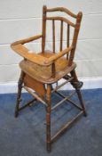 A 20TH CENTURY OAK METAMORPHIC HIGH CHAIR, with open armrests, and a fold away foot rest, height