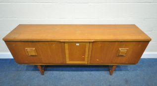 A MID CENTURY TEAK SIDEBOARD, fitted with two bi-fold doors, flanking a central door, with