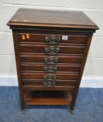 A 20TH CENTURY MAHOGANY MUSIC CABINET, fitted with six fall front drawers, an undershelf, raised