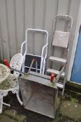 AN ALUMINIUM STEP LADDER, a two step ladder, a galvanised wheelbarrow, and a stained beech garden